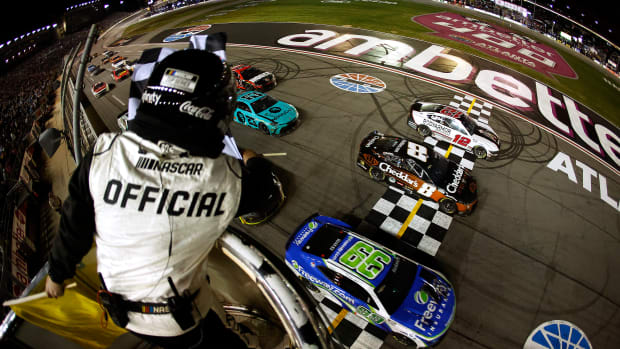 Daniel Suarez crosses the finish line ahead of Kyle Busch and Ryan Blaney to win the NASCAR Cup Series Ambetter Health 400 Sunday at Atlanta Motor Speedway. (Photo by Alex Slitz/Getty Images)